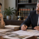 Person consults a defense attorney as they review case papers and a property floor plan.