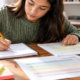 A student drafts a constructed response while checking highlighted source evidence and a scoring rubric.