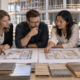 Construction team comparing building layout options, material samples and a project model