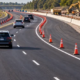 Road construction lane taper guides traffic through a gradual shift with cones and clear pavement markings