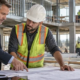 Contractor and owner reviewing plans before a commercial construction loan