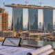 Marina Bay Sands construction phases with cranes and a project planner reviewing the site schedule