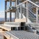 Engineers inspect fabricated steel handrails, stair components, grating and connection plates for a building project.