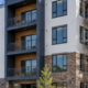 Four-story apartment building under construction with repeated homes and balconies shows the scale of a 20-unit multifamily project.