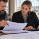 Construction estimator calculating labor burden rate with payroll records