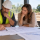 Construction team reviewing building plans before pre-construction work begins