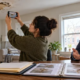 Tenant documents water damage in a rental apartment while reviewing records with a legal adviser.