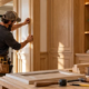 Finish carpenter installs custom millwork and wood trim in a nearly completed home.
