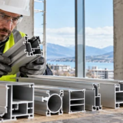 Engineer inspects hollow aluminum window profiles to confirm the extruded shapes fit the building assembly.