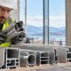 Engineer inspects hollow aluminum window profiles to confirm the extruded shapes fit the building assembly.