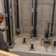 An engineer and elevator installer review guide rails, buffers, drainage, and ladder access inside a protected elevator pit.