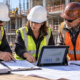 Project manager, estimator, and superintendent compare a baseline budget, current costs, invoices, and construction progress at a commercial jobsite