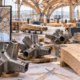 An engineer compares a digital structural model with CNC-fabricated timber members and steel nodes ready for assembly.