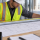 An estimator measures conduit alongside an electrical plan to confirm the linear-foot quantity before pricing materials.
