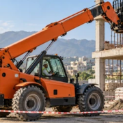 A telehandler lifts a pallet of bricks to an upper floor while a spotter keeps workers outside the exclusion zone.