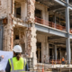 Engineers review a renovation where an existing masonry facade meets new structural framing, showing when work becomes substantial reconstruction.