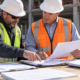 Subcontractor and general contractor verify an invoice, payment notice, and work records at an active commercial construction site