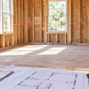 Builder and homeowner measuring a framed room to estimate cost per square foot