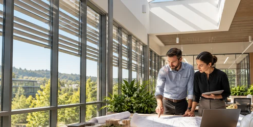 Architects discuss daylighting in a commercial interior with high windows, skylights, and exterior sun shades.