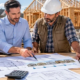 Homeowner, lender, and contractor review a construction budget, staged draw schedule, and inspection checklist beside a house under construction