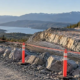 Construction supervisor maintaining a safe exclusion zone at a controlled rock excavation site