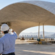Architects inspecting a curved thin-shell concrete roof under construction