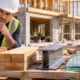 Site professional compares concrete block, brick, timber, steel, glass and stone at a building site.