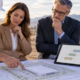 An estimator, architect, and owner review a preliminary concept plan and rough cost range for a proposed commercial building.