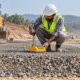 Engineer checks compaction and moisture of dense graded aggregate in a prepared road base layer