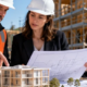 Architect and contractor compare a building model with plans at an active project site, linking design choices to field construction.