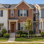 Attached single-family homes share side walls while each unit has its own entrance and a small front yard.