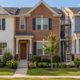 Attached single-family homes share side walls while each unit has its own entrance and a small front yard.