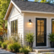 Detached backyard cottage with a private path beside the main home illustrates a small back house or accessory dwelling unit.