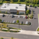 Commercial building site plan for a one-acre lot showing building footprint, parking, setbacks, access road, and landscaped open space.