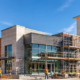 Office, retail, and hospitality buildings at different stages of development line an urban commercial construction area.