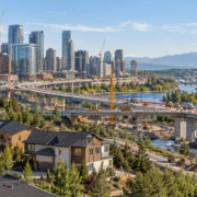 construction-industry-sectors-feature-image Panoramic city-development scene spanning homebuilding, commercial towers, bridge construction, and industrial facilities to show construction’s main sectors.