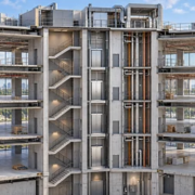 Commercial building cutaway showing the completed outer shell and central service core with open unfinished floors awaiting tenant fit-out.
