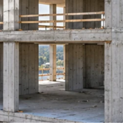 Architect inspects intersecting load-bearing concrete walls in a multistory building, showing the cross-wall structural layout.