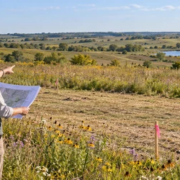 Landowner and consultant review a proposed home site on conservation grassland while keeping native habitat and wetlands intact.