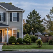 Two-unit duplex with paired entrances stands beside a detached single-family home with one main door, showing the difference in layouts.