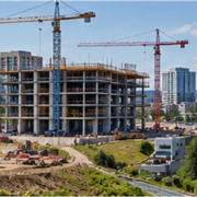 Residential houses, commercial buildings, and a bridge project under construction show different kinds of construction.