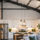 Metal building conversion combines a steel-frame shell with new insulated wall framing and a bright finished home interior.