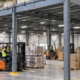 Steel warehouse mezzanine adds elevated storage space with a guarded stair and work zone below.