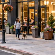 Modern mixed-use building places ground-floor shops below apartments and balconies, bringing separate business and residential spaces into one city block.
