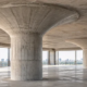 Reinforced concrete flat slab supported by columns with flared mushroom-shaped capitals that spread support across the slab.