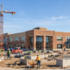 Office, healthcare, and educational buildings at different stages of construction illustrate non-residential projects.