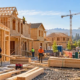 Workers frame new homes in a growing US residential construction development.