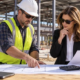 Texas commercial construction site with contractor and property owner reviewing project plans, an invoice and calculator to track sales tax and building costs.