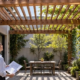 Architect reviews a timber trellis integrated with a home courtyard, showing how the structure filters sunlight and supports climbing plants.